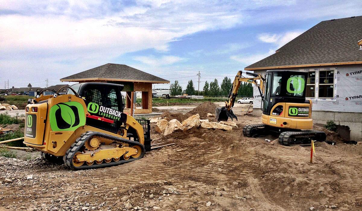 large machines move boulders for landscaping