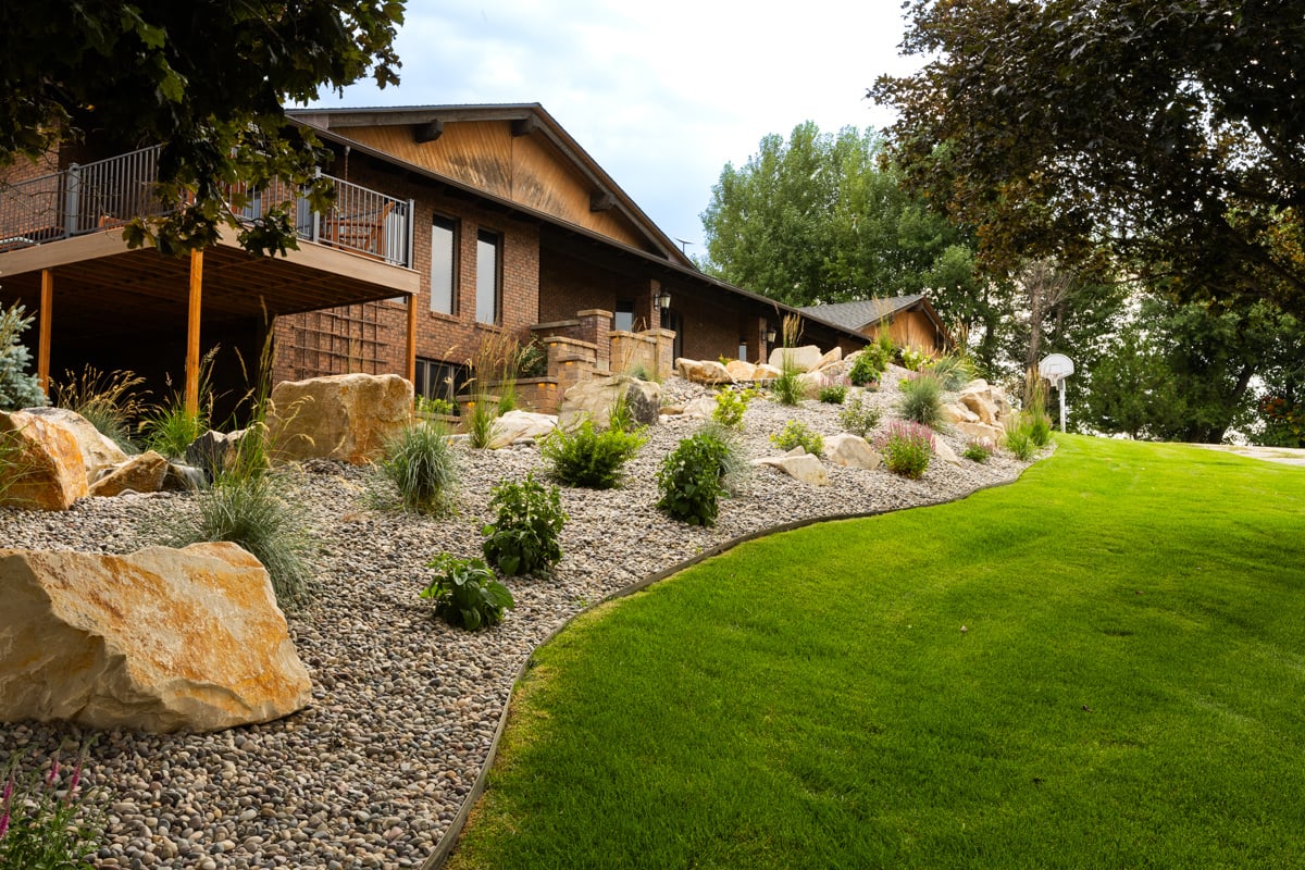 lawn turf grass green yard plants bed gravel boulders deck home