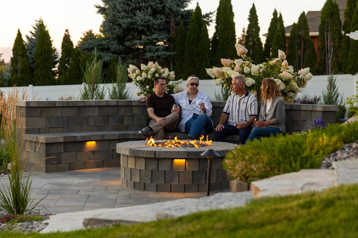 customers family fire pit paver patio walkway sitting wall lighting plants gravel bed pergola 9