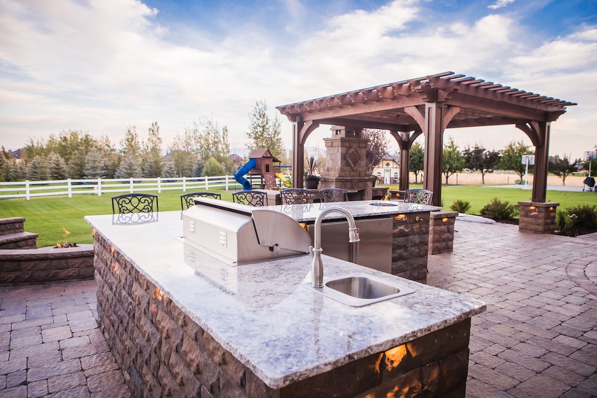 outdoor kitchen on patio with fireplace