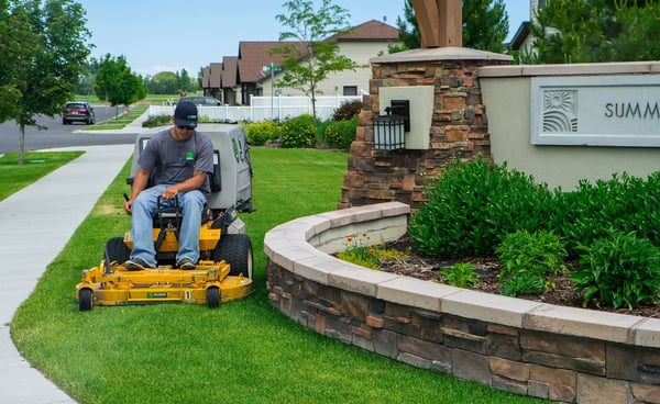 Outback Landscape crew member mowing in morning