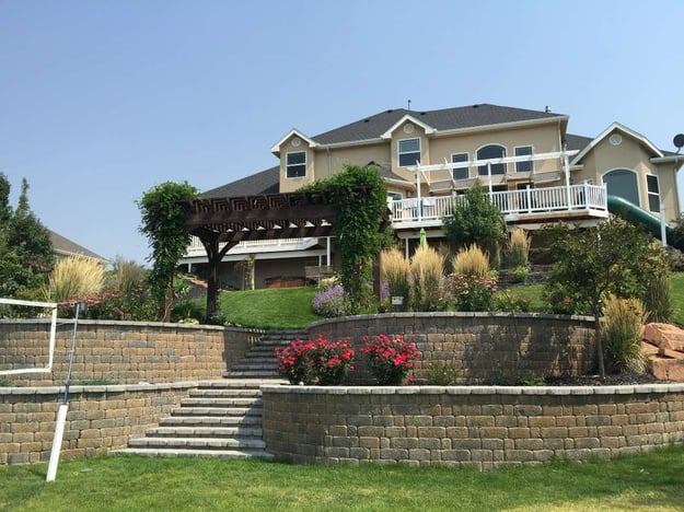 landscape construction with retaining walls and pergola