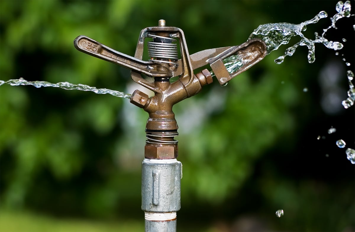 old sprinkler watering grass