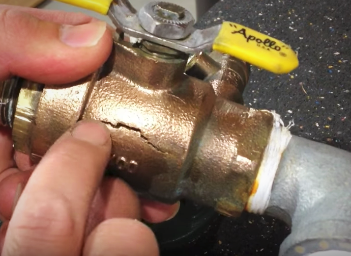 irrigation technician holds cracked valve in hands