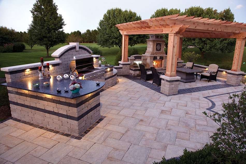 outdoor kitchen with grill, pergola, and fireplace
