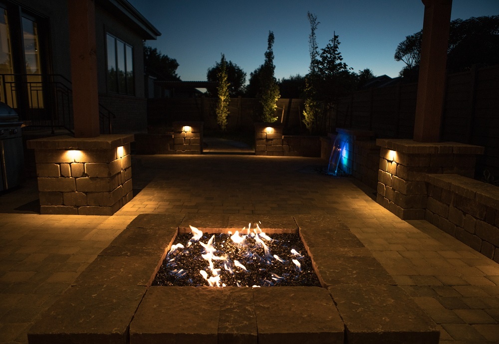 Downlights landscape lighting on patio with fire pit