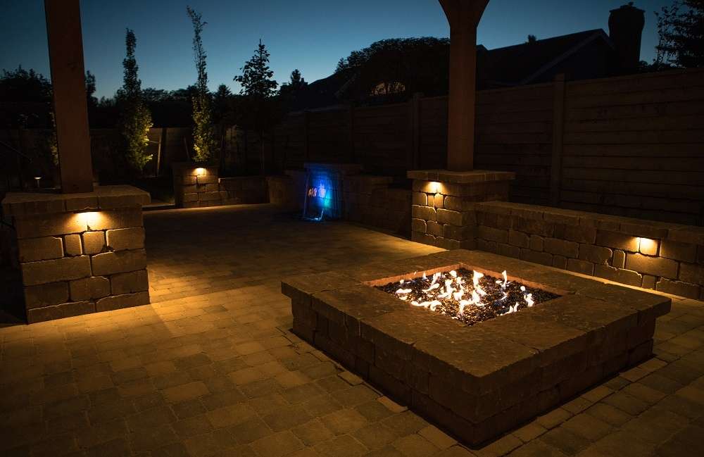 patio with landscape lighting and fire pit