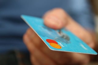 a shopper handing over a credit card