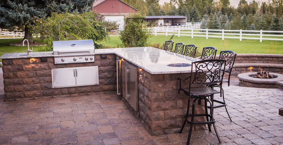 large outdoor kitchen with bar and grill