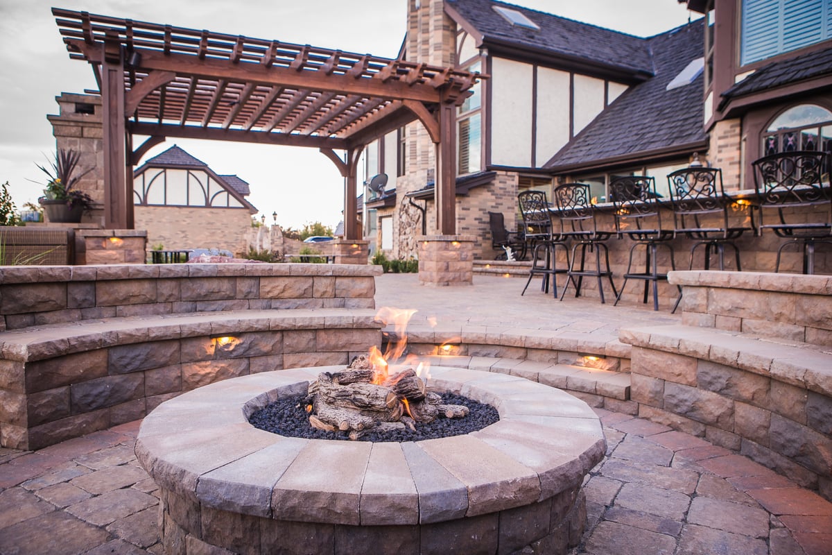 landscape lighting built into seat wall near firepit