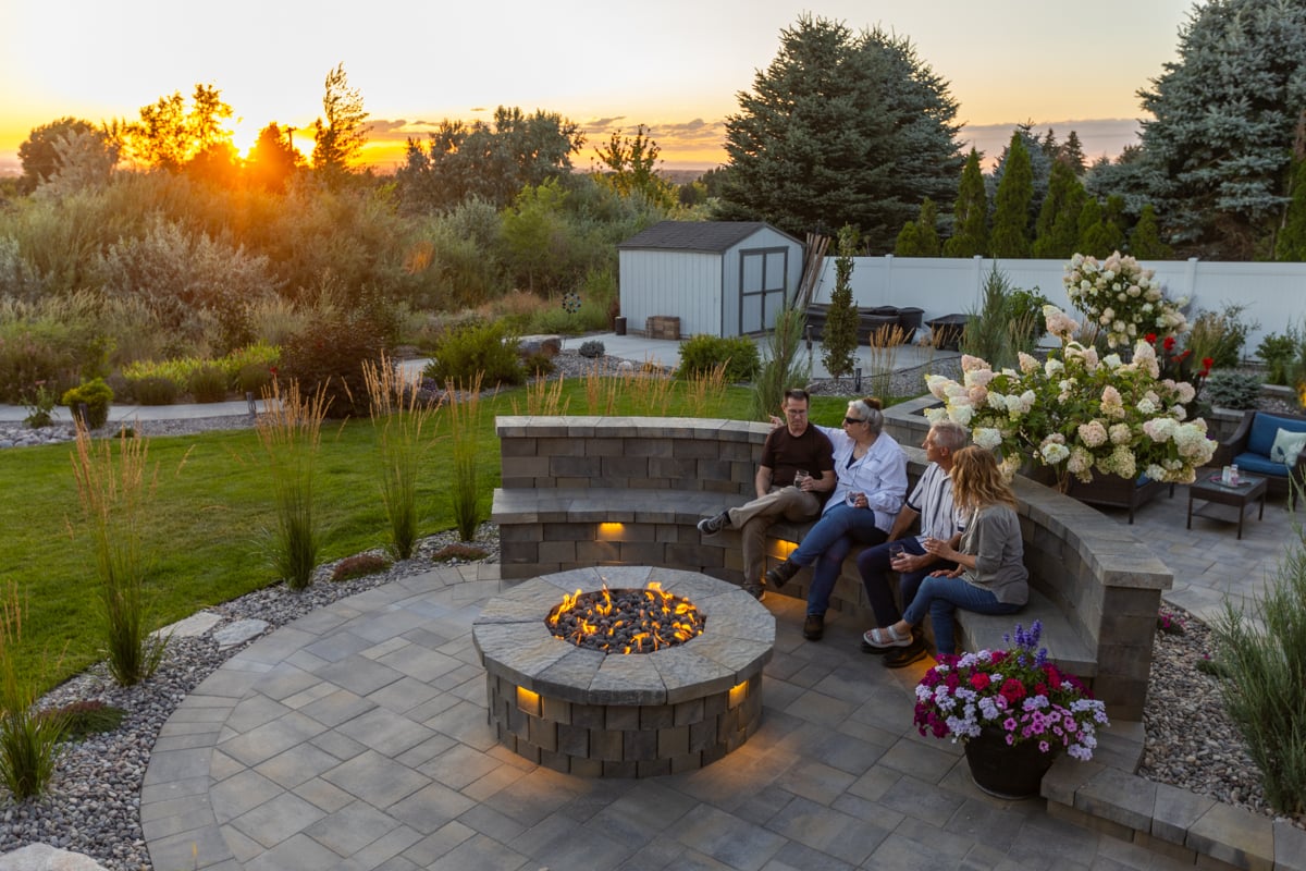 customers family fire pit paver patio walkway sitting wall lighting plants gravel bed pergola nice yard