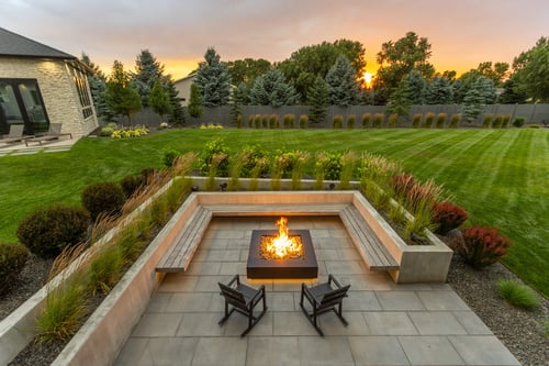 firepit seating bench raised planter plants patio grass green turf lawn yard nice