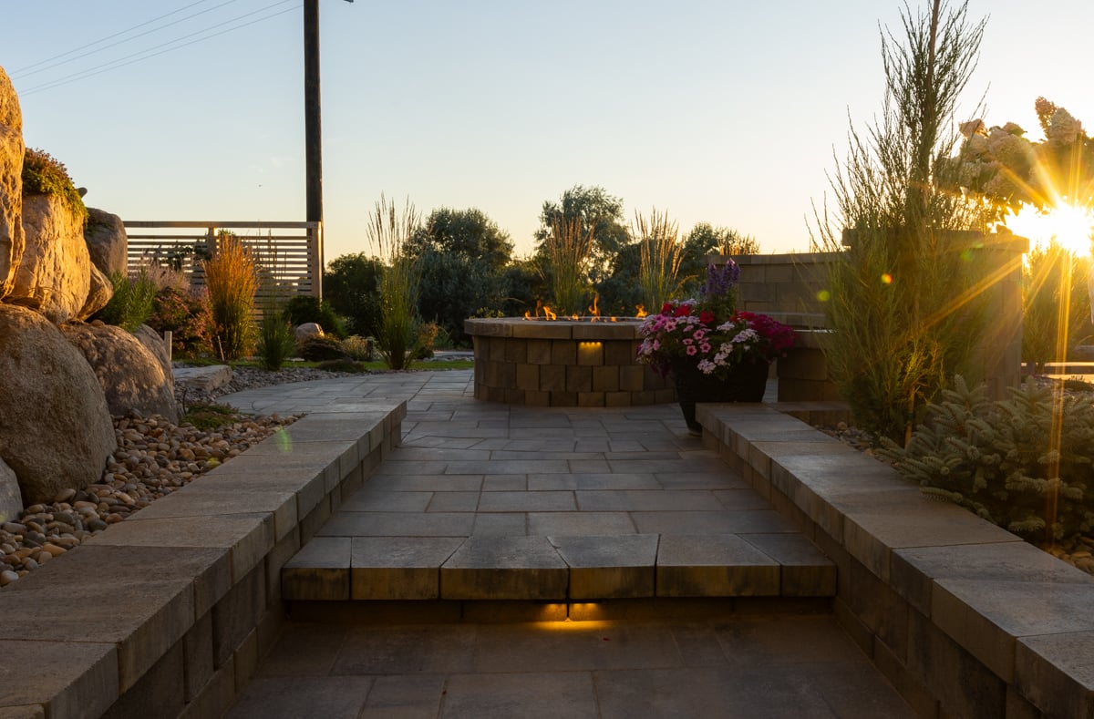 hardscape fire pit landscape lighting sitting wall paver patio furniture stone stairs sunset 2-1
