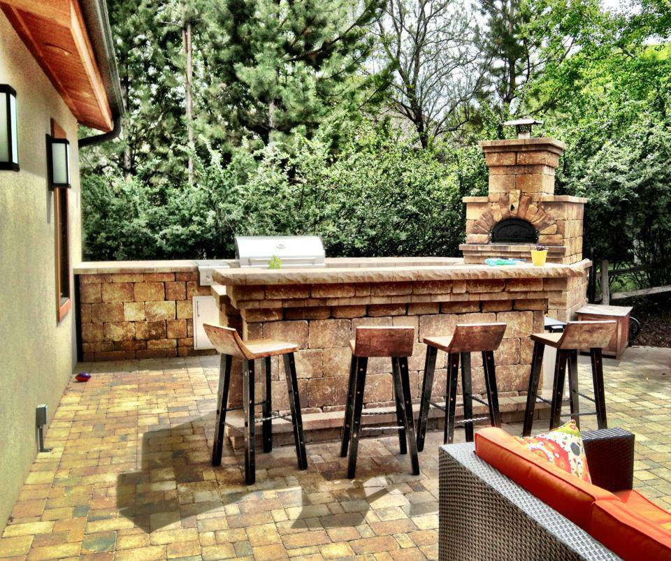 outdoor kitchen with patio furniture and brick patio