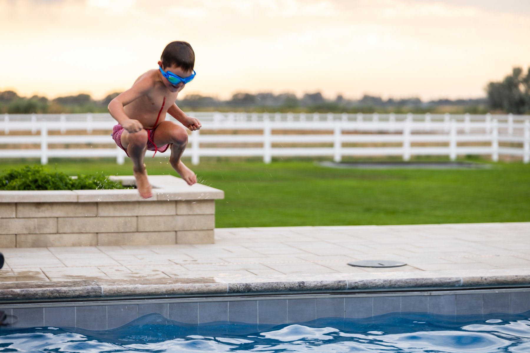 landscape construction customer children playing pool patio coping edge