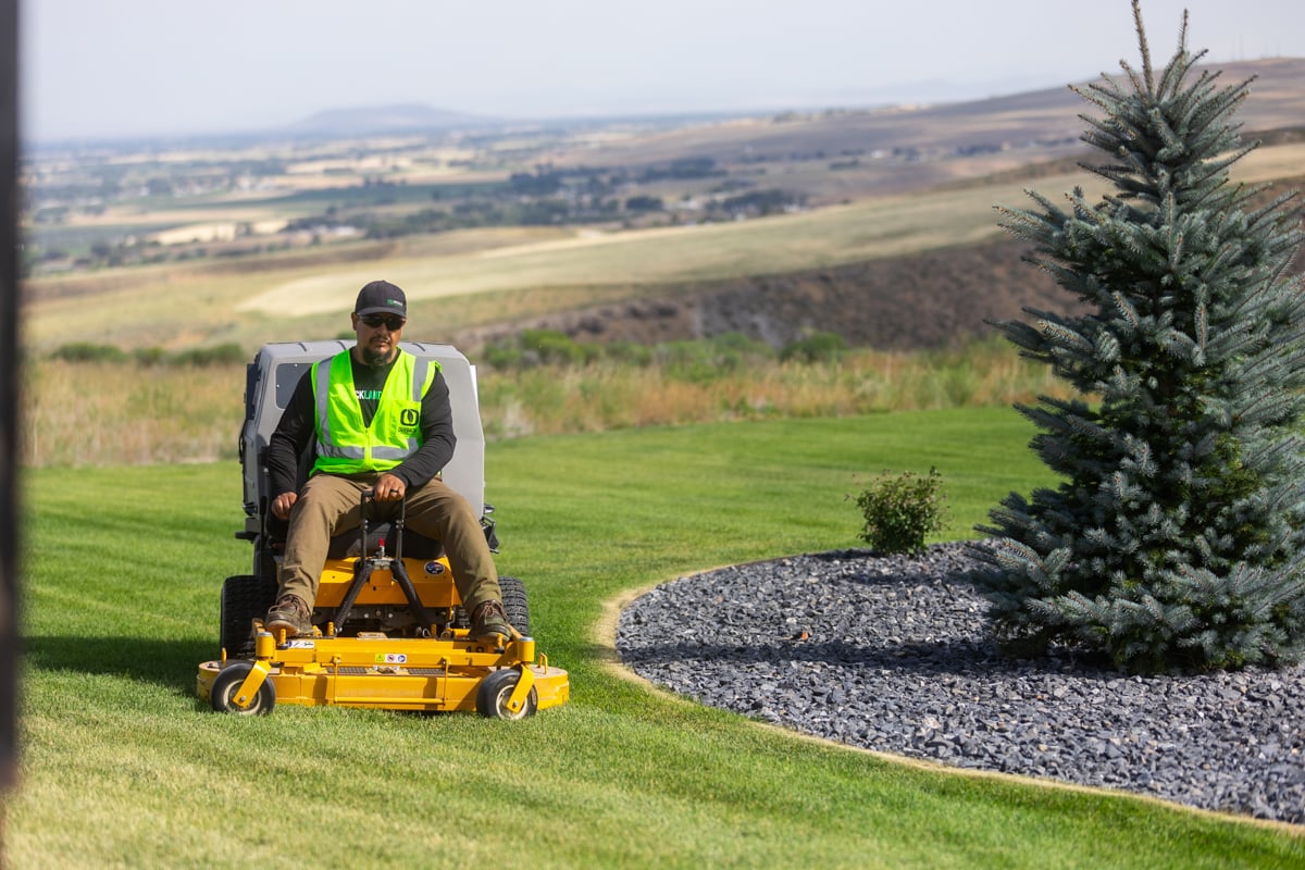 residential maintenance team crew lawn mowing trimming gravel bed 4