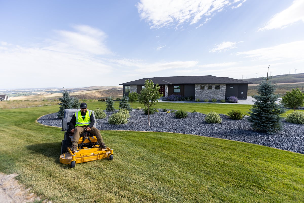 residential maintenance team crew lawn mowing trimming gravel bed big sky 2
