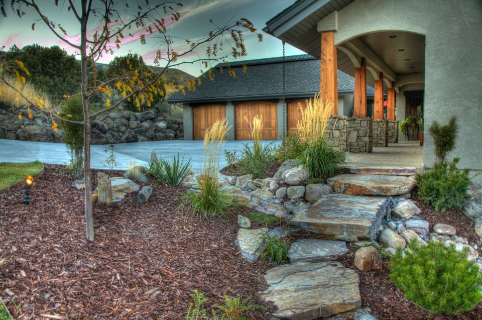 mulch plantings and stone near entrance to home