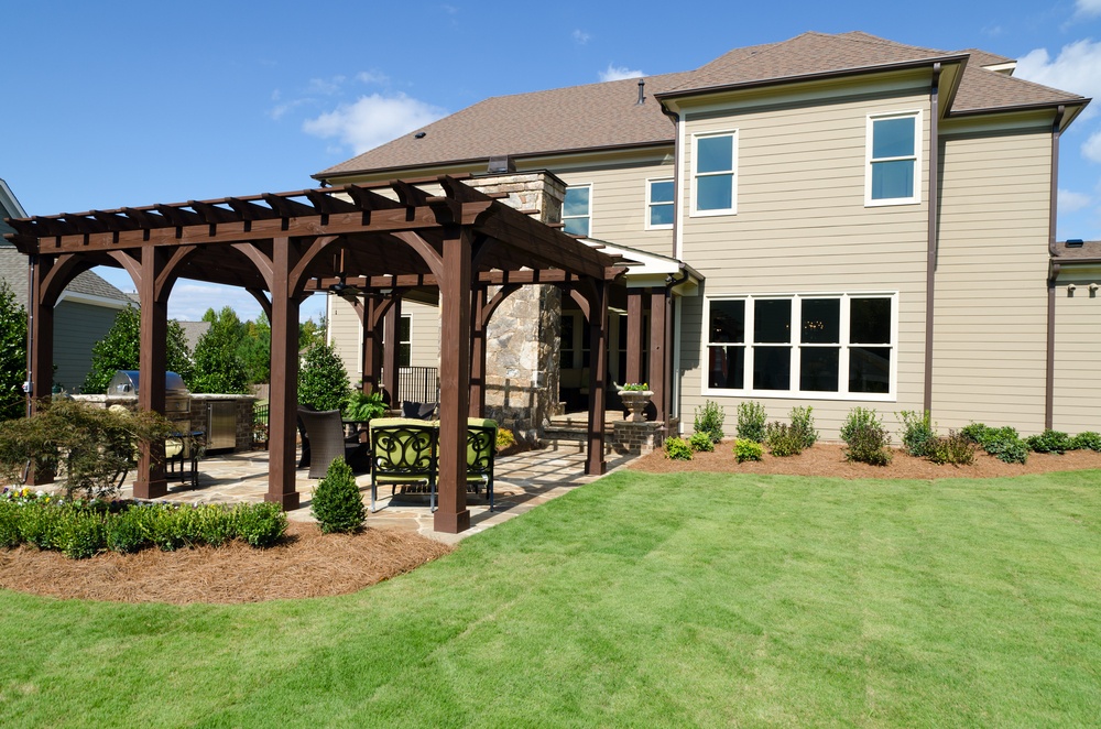 pergola and patio with outdoor kitchen