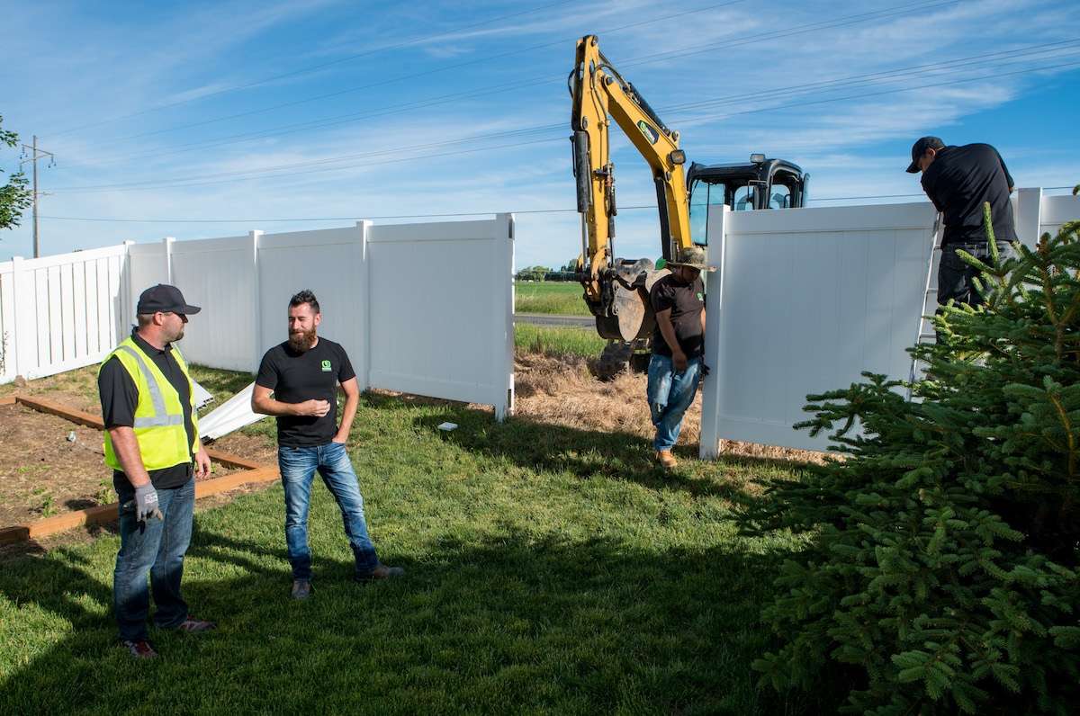 landscape team meeting near fence