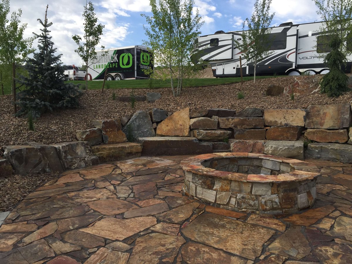 natural stone fire pit with patio