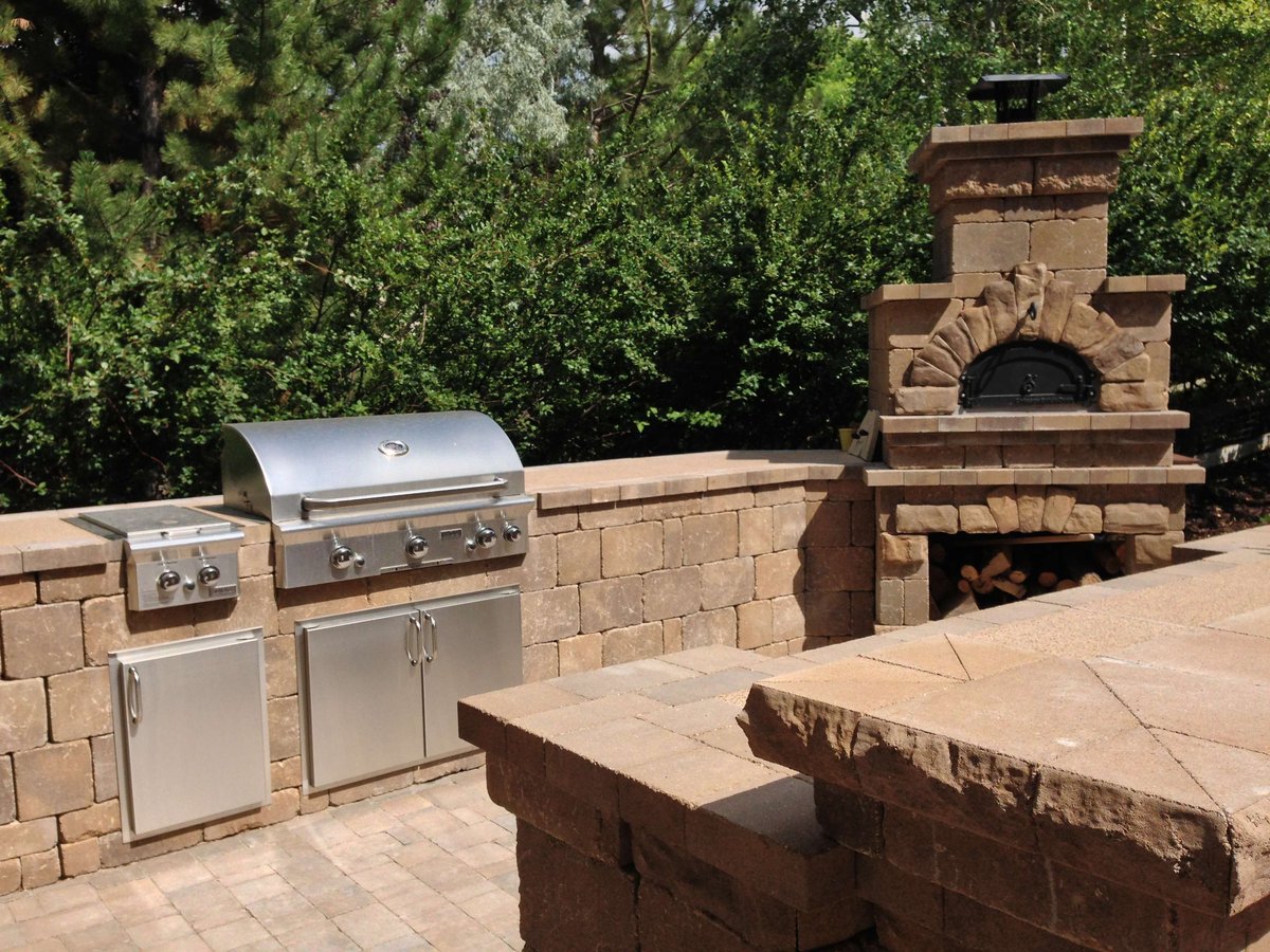 Outdoor kitchen with grill and fireplace