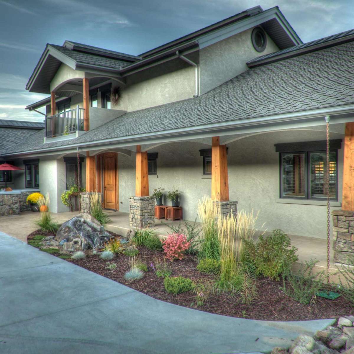 front entrance of home with neat landscape beds and plantings