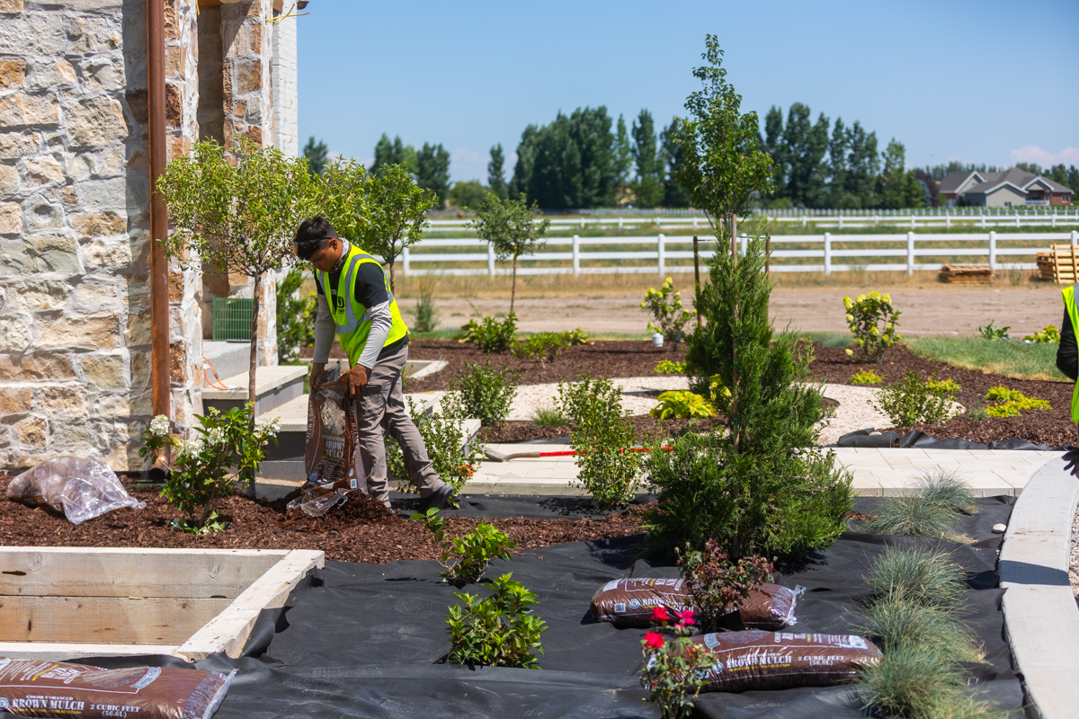 maintenance crew team mulch installation foundation planting beds