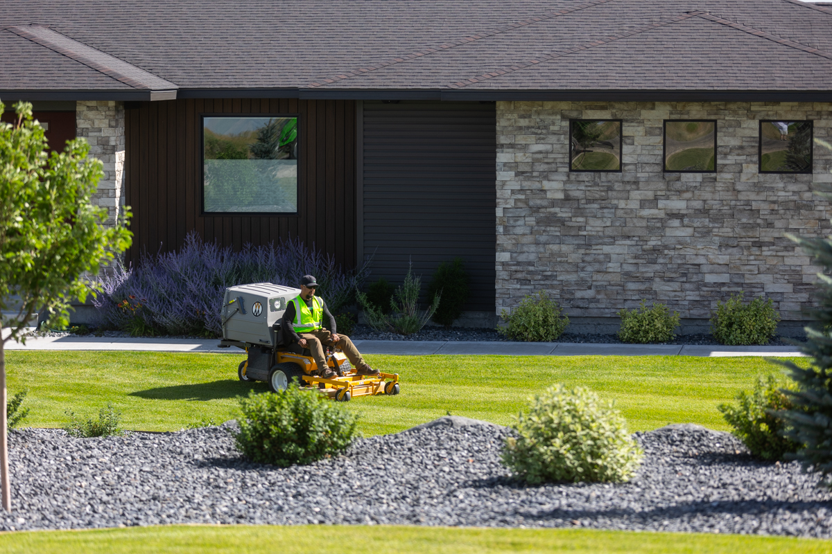 residential maintenance team crew lawn mowing trimming gravel bed plants nice home 2