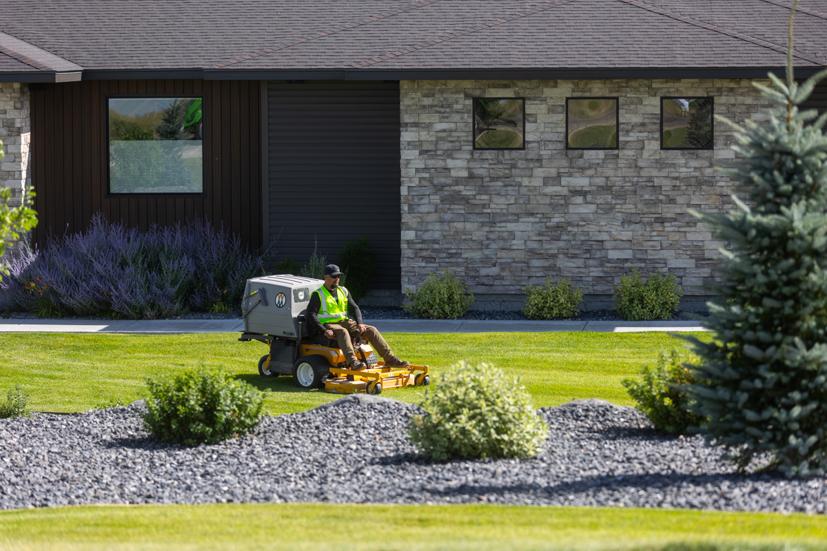 residential maintenance team crew lawn mowing trimming gravel bed plants nice home 3