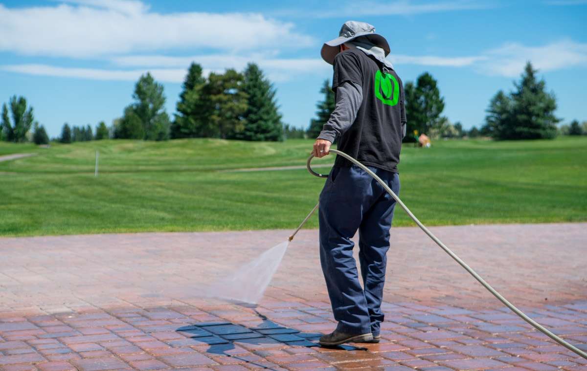 crew member maintaining pavers