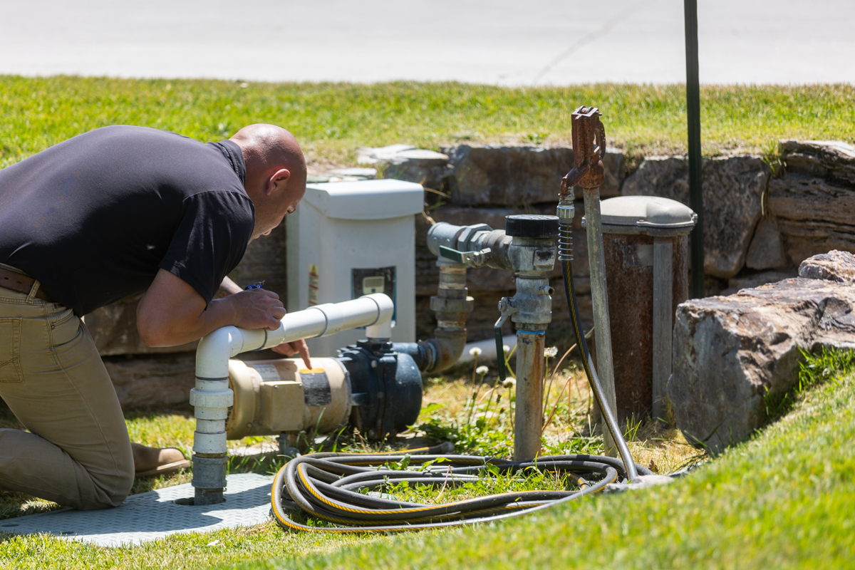 irrigation expert calibrating a large sprinkler system in an idaho falls landscape