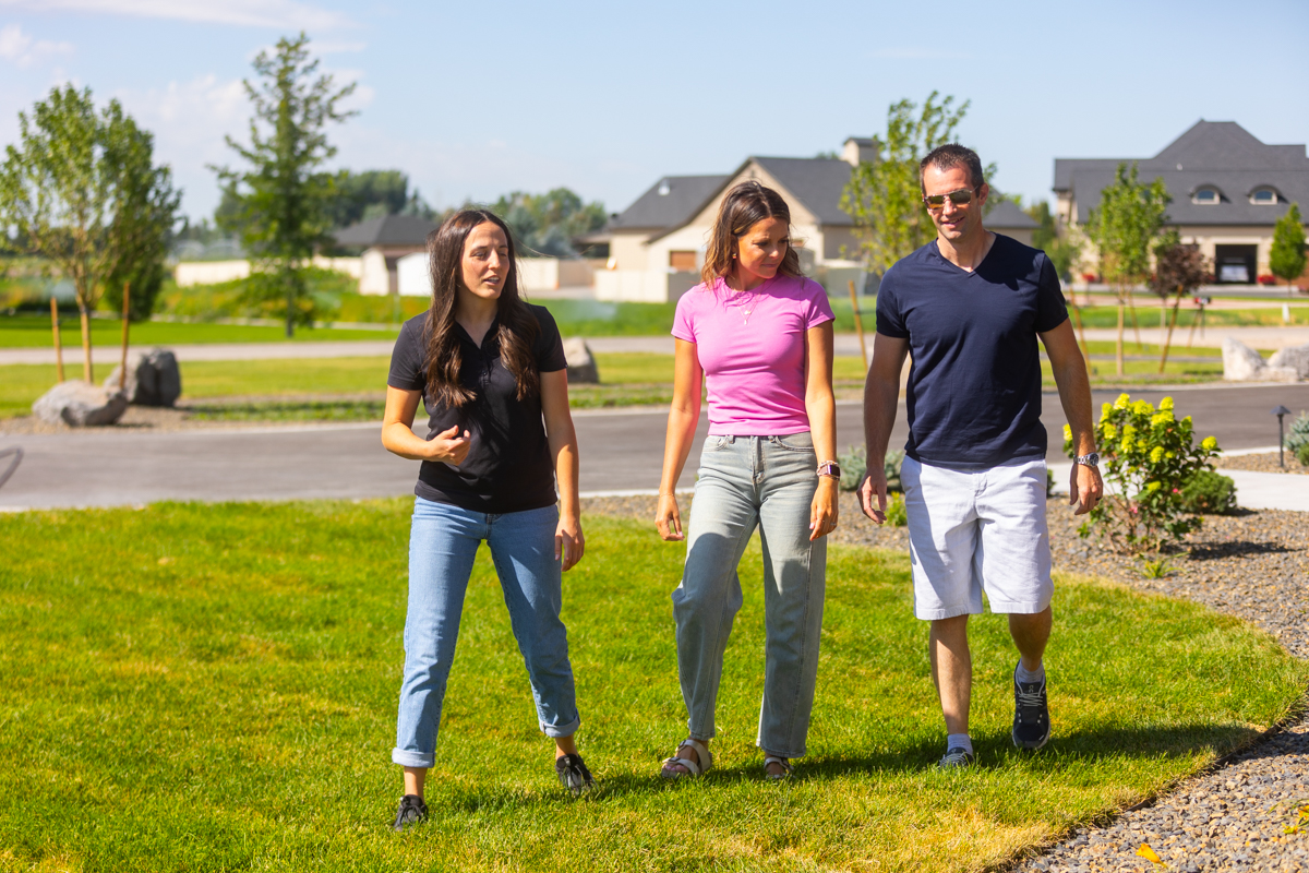 landscape designer and homeowners walking through a nice idaho falls backyard during landscape consultation