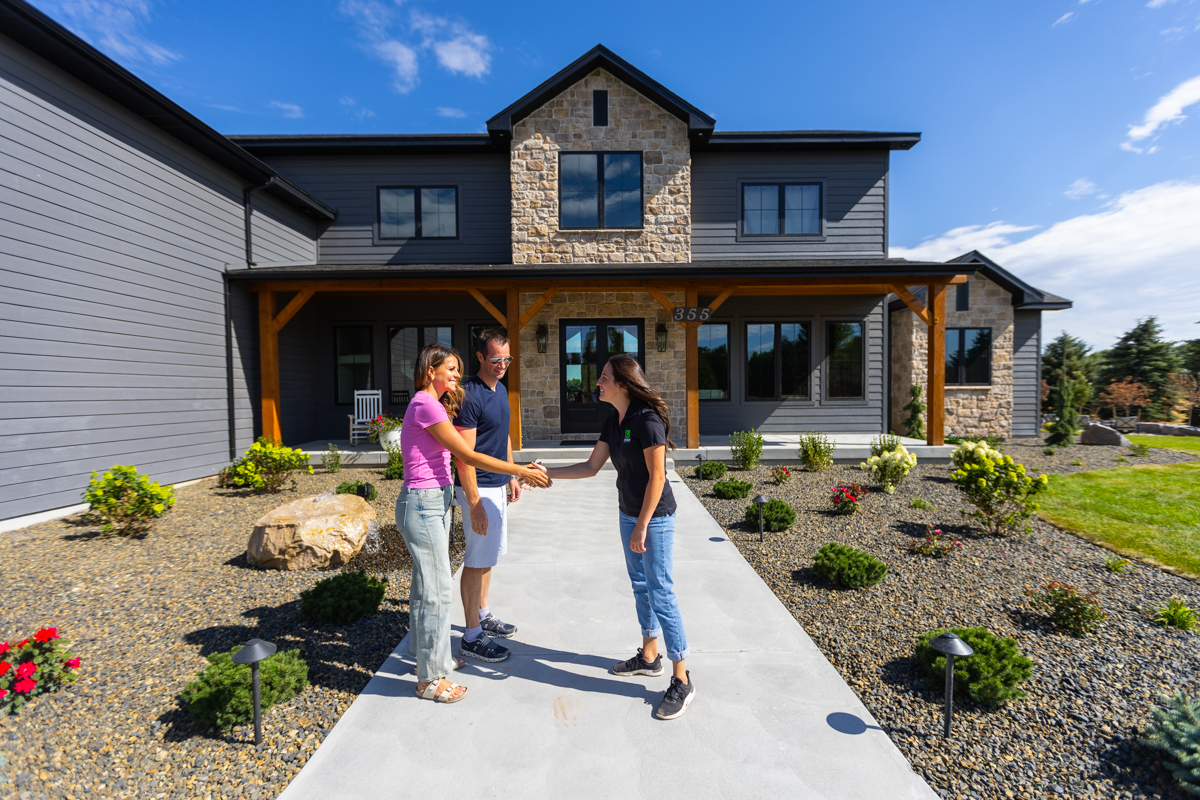 landscape designer and homeowner meeting outside a nice idaho falls home