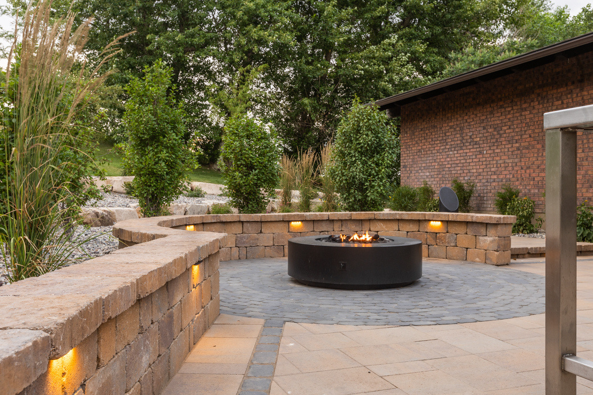 firepit wall patio paver trees plants