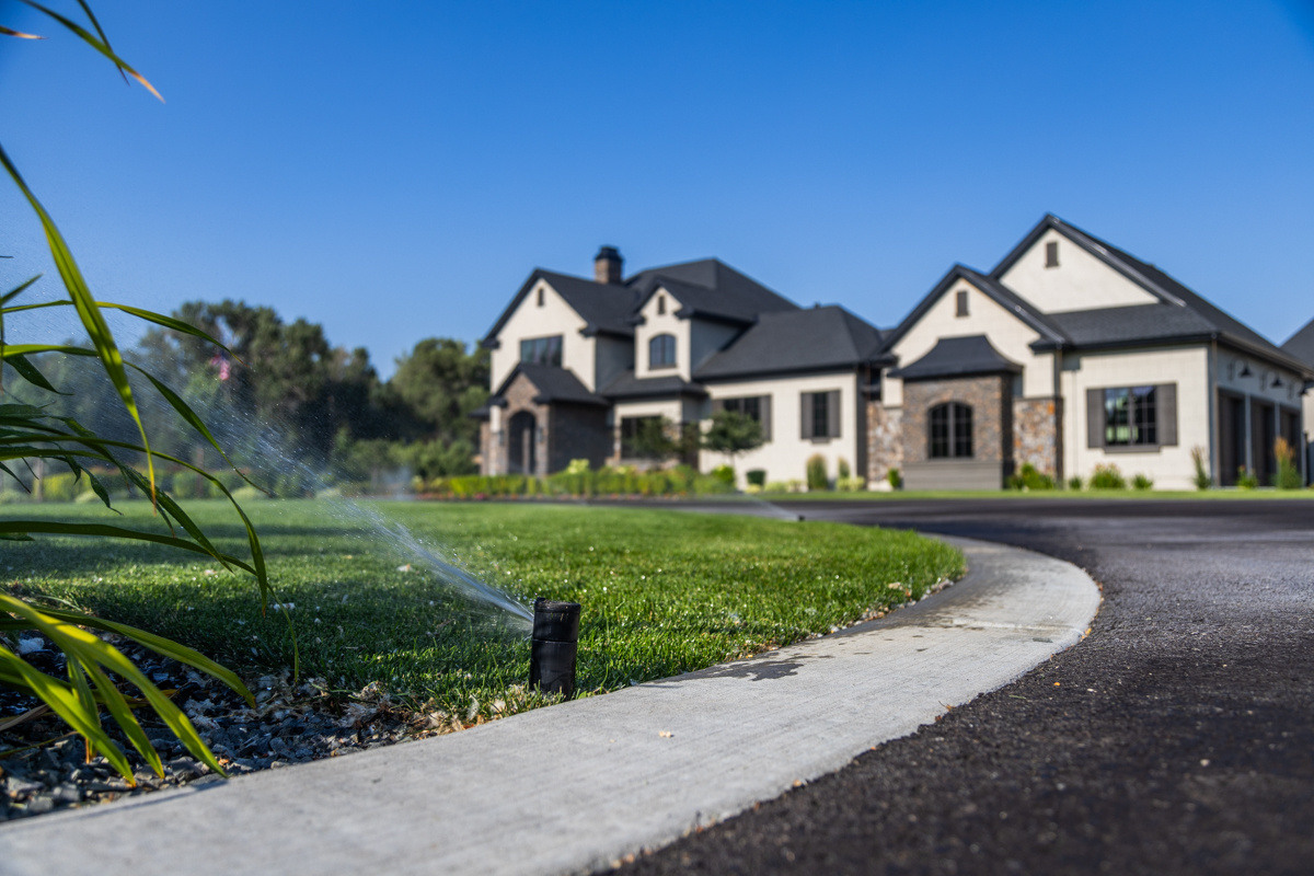irrigation sprinkler water turf grass green lawn driveway home house