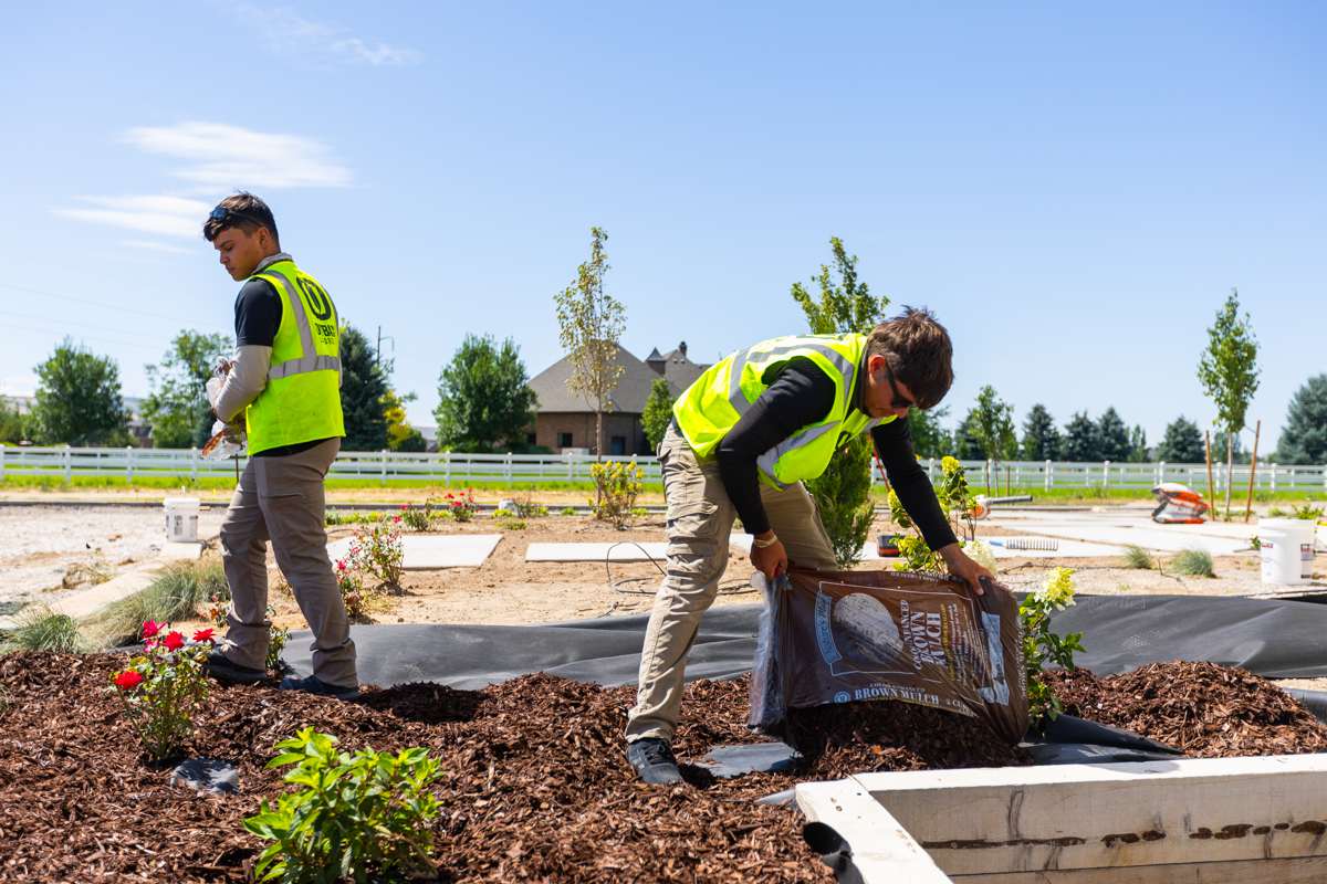 landscape maintenance crew installing mulch on a nice idaho falls property