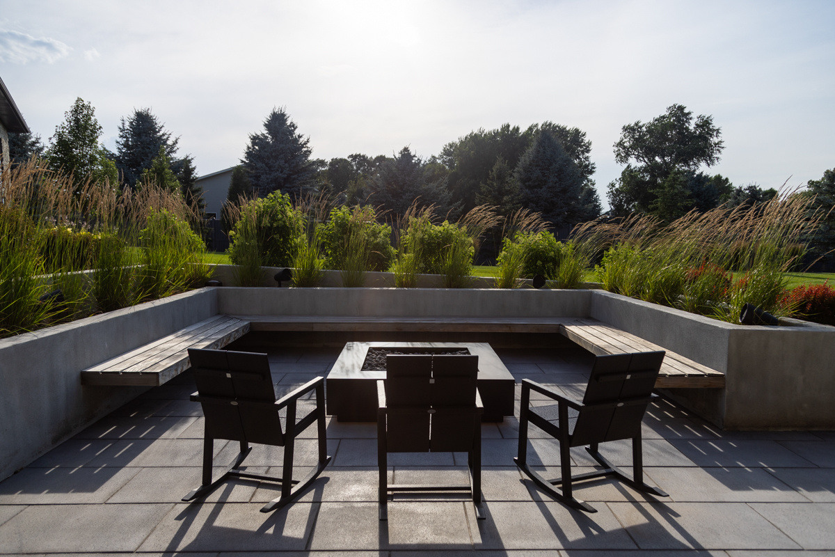 patio seating bench firepit plants grass shrubs raised planters chairs