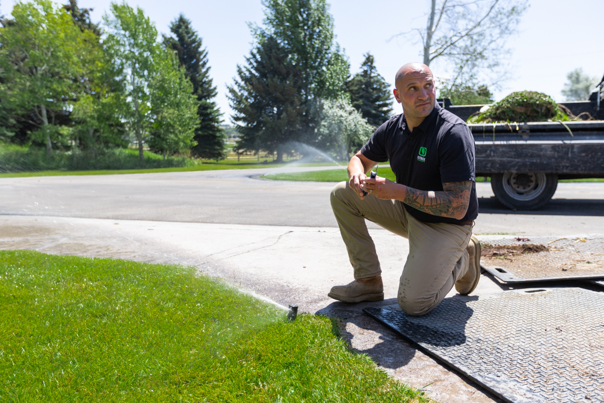 irrigation technician calibrating a lawn sprinkler system in idaho falls
